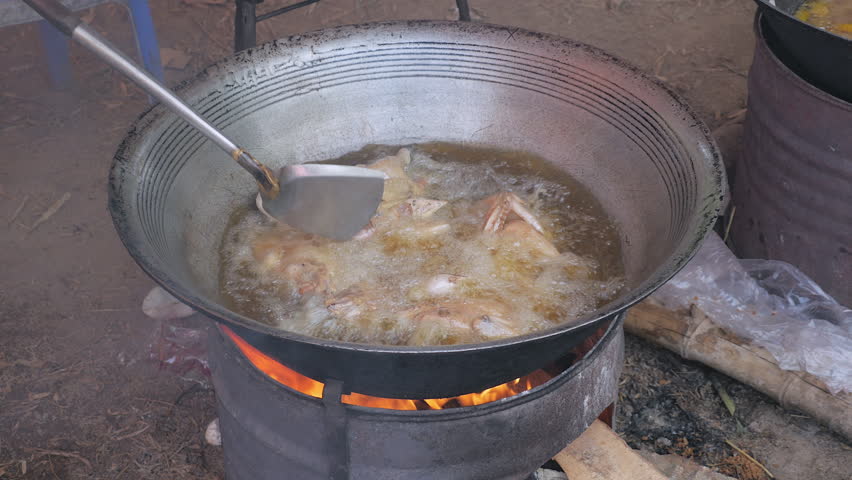 Stir Frying Ens In A Large Wok Cooking On Charcoal And Wood Brazier Stove Outdoors Stir Frying Ens In A Large Wok, Outdoor Wok Cooking