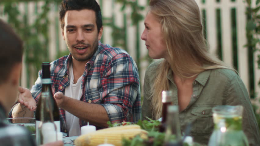 Smiling Hispanic Ethnicity Man Communicating with a Young Woman at Outdoor Family Dinner. Shot on RED Cinema Camera in 4K (UHD). | Shutterstock HD Video #20914255