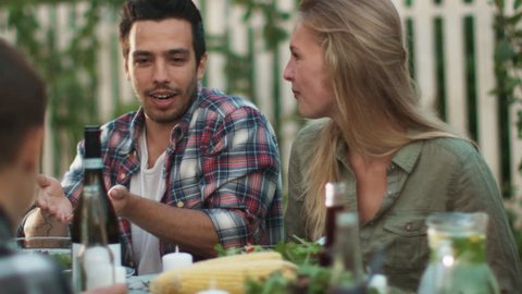 Smiling Hispanic Ethnicity Man Communicating with a Young Woman at Outdoor Family Dinner. Shot on RED Cinema Camera in 4K (UHD).