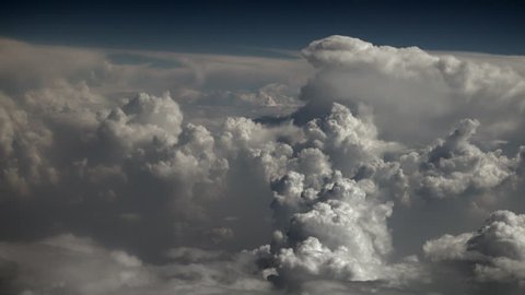 Thick clouds seen through the airplane window above the ground