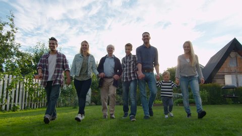 Family of Seven Walks on Camera. They're in the Backyard. Shot on RED Cinema Camera in 4K (UHD). Stock Video