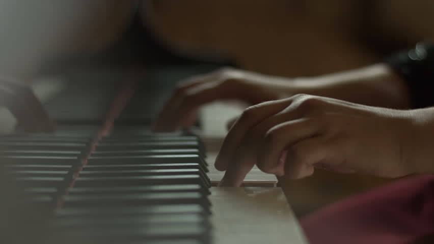 Close-up shot of woman's hands playing piano. | Shutterstock HD Video #20917996