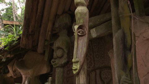 Osogbo, Nigeria - August 2013;Carved faces at entrance of pavilion