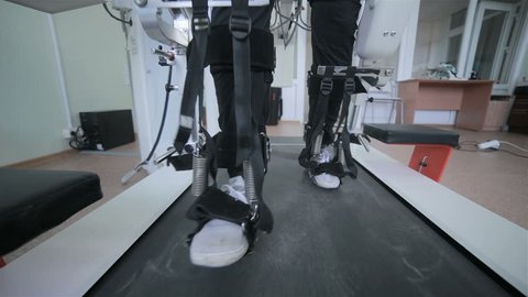 Man with innovative robotic VR cybernetic system walking like a robot. Hi-tech game industry and motion tracking in cyberspace.