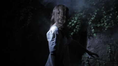 VIRGINIA - SUMMER 2016 - Reenactment, Recreation -- Ghostly, undead woman in smoky haunted garden outside.  Paranormal, poltergeist.  Mystery woman with pale pallor, 19th century clothing, flowing.