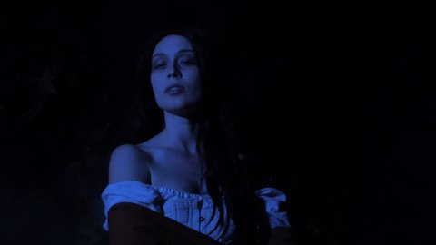 VIRGINIA - SUMMER 2016 - Reenactment, Recreation -- Ghostly, undead woman in smoky room in haunted house.  Paranormal, poltergeist.  Mystery woman with pale pallor, 19th century clothing in darkness