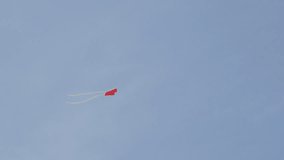 Attached on string colorful paper flying dragon on the wind 4K 2160p 30fps UltraHD footage - Red and green kite relaxing movements against blue sky 3840X2160 UHD video