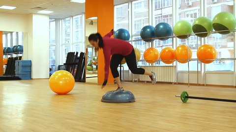 Rostov on Don, Russian Federation - January 05, 2014: Young woman doing fitness exercise with bosu ball.