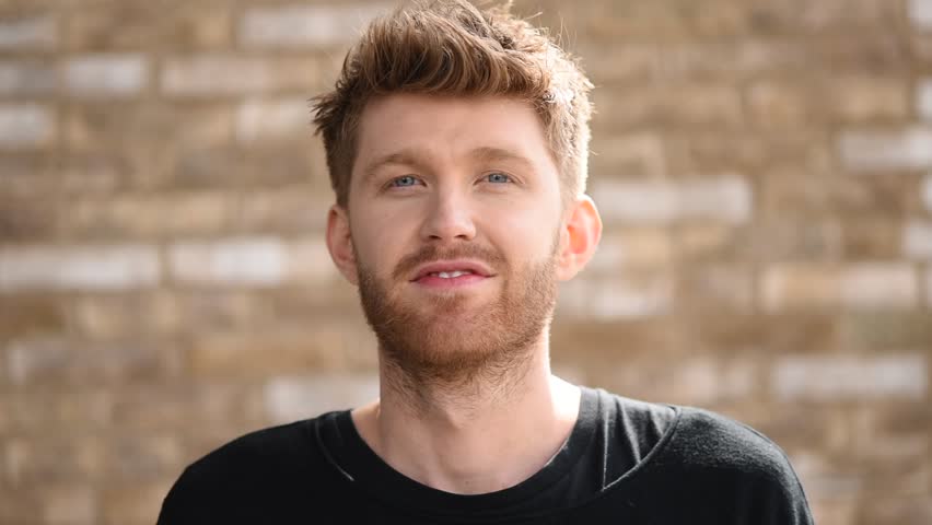 Carefree young handsome guy blowing a kiss