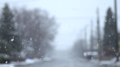Defocused blizzard with car driving by