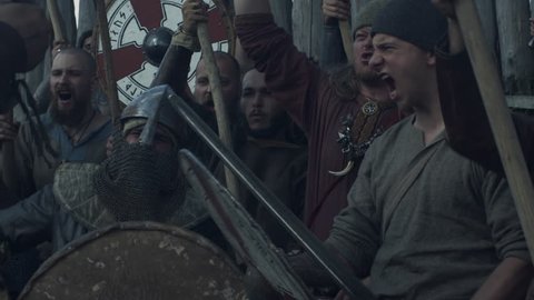WOLIN, POLAND - 06.08.2016: Army of Vikings Screaming before the Battle during Slavs and Vikings Festival. Medieval Reenactment. Shot on RED Cinema Camera in 4K (UHD).