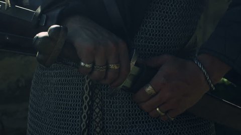 Portrait of a Warrior is Drawing his Swords. Medieval Reenactment. Medieval Reenactment. Shot on RED Cinema Camera in 4K (UHD).