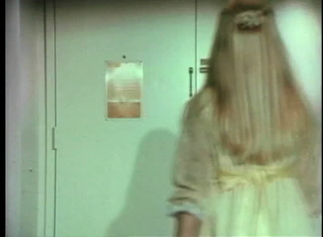 Rear view of blonde girl opening door