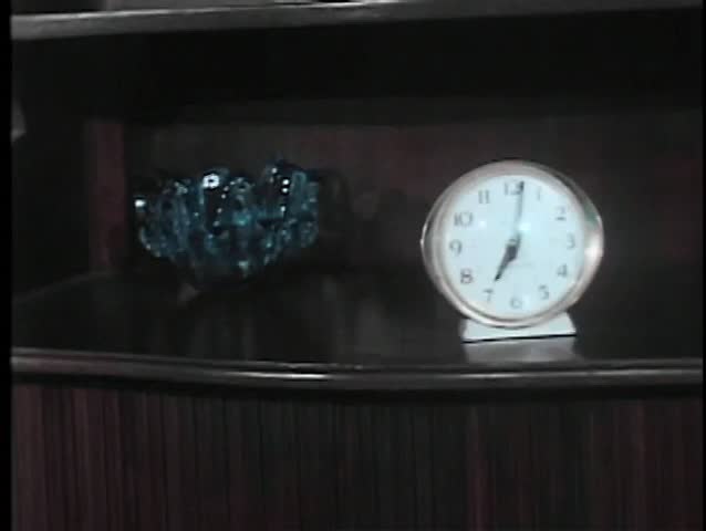 Hand reaching to shut off alarm clock