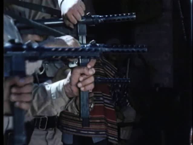 Medium shot of soldiers firing machine guns