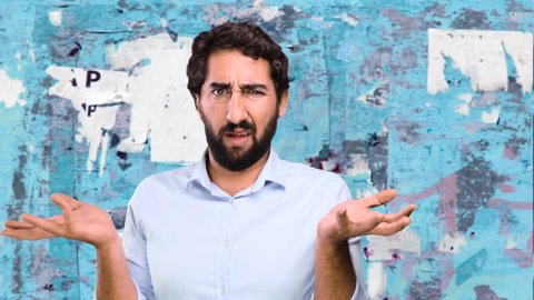 young funny man confused on grunge wall
