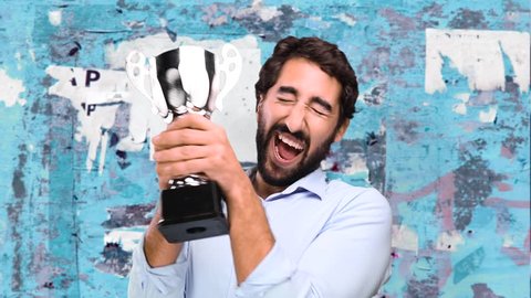 young funny man winning a cup on grunge wall