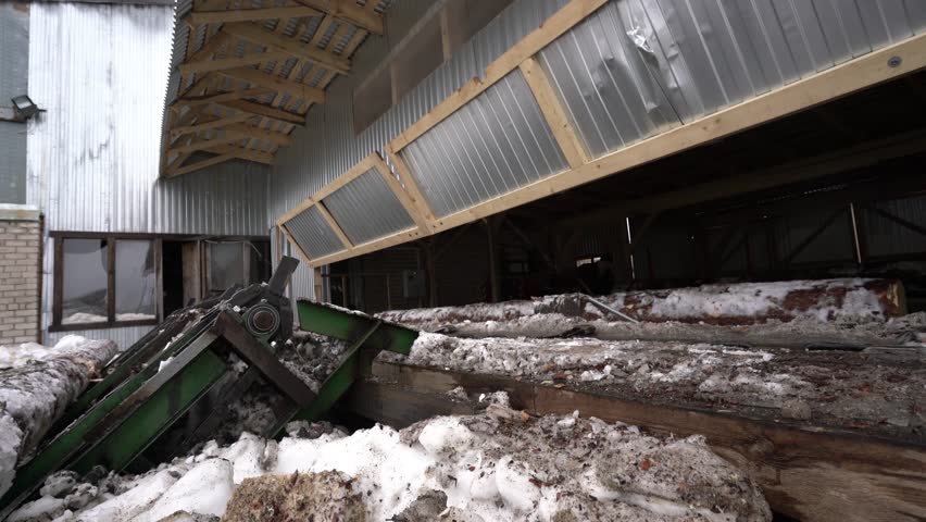 Timber mill in winter time. View of conveyor