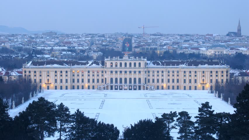 Schoenbrunn palace stands against evening city, time lapse