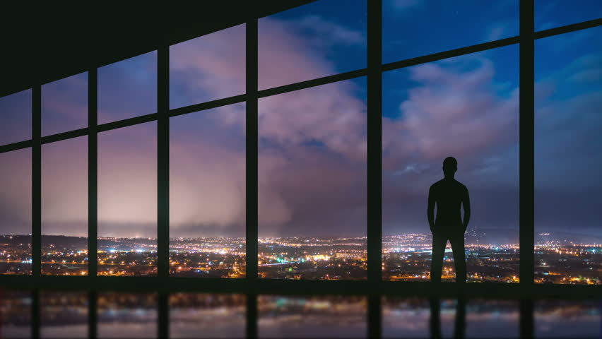 5 in 1 video! The man stand at the panoramic window on the background of night the city. Time lapse. Wide angle Royalty-Free Stock Footage #20977306