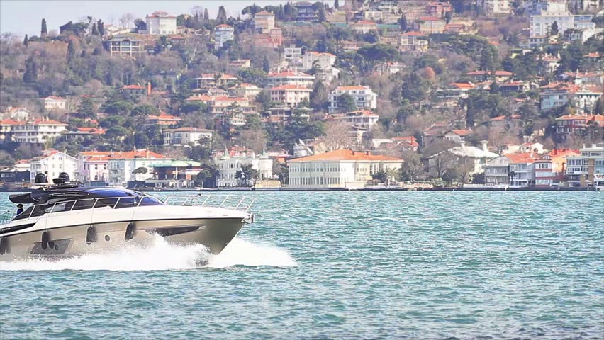 Luxury white yacht sails in Bosporus waters
