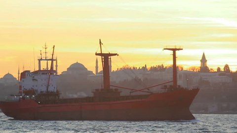 Cargo ship sails on sunset in Istanbul
