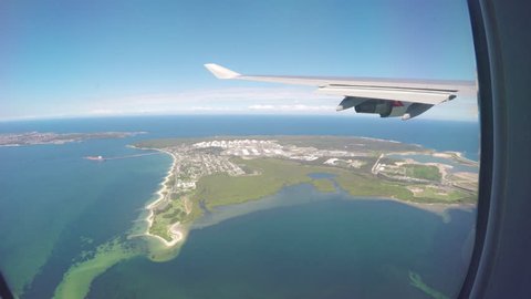 SYDNEY, AUSTRALIA - 2016: Window View from Inside Flying Qantas Boeing 747 Jet Airliner Flying Over Pacific Ocean After Talking Off from Sydney Australia