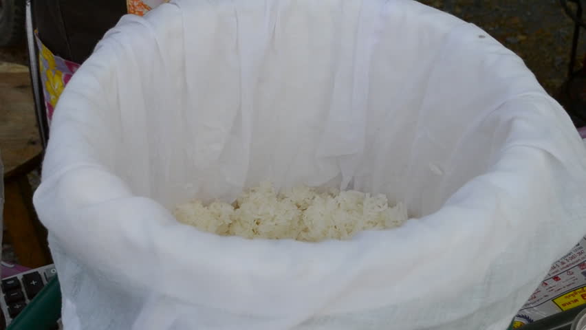 Scooping sticky rice into bag