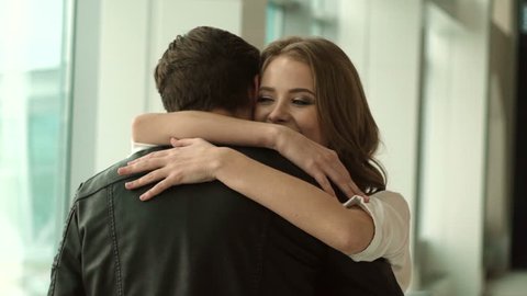 couple meeting at the airport. boyfriend hugging his girlfriend. real emotion