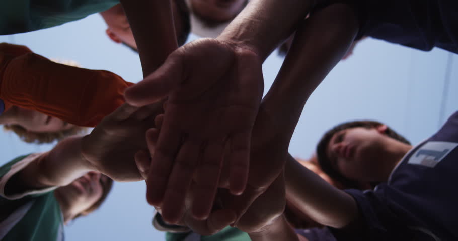 Low angle shot of a youth soccer / football (european) team doing a hands in cheer before the big game. Version 3 (two takes in one clip) Royalty-Free Stock Footage #20993917