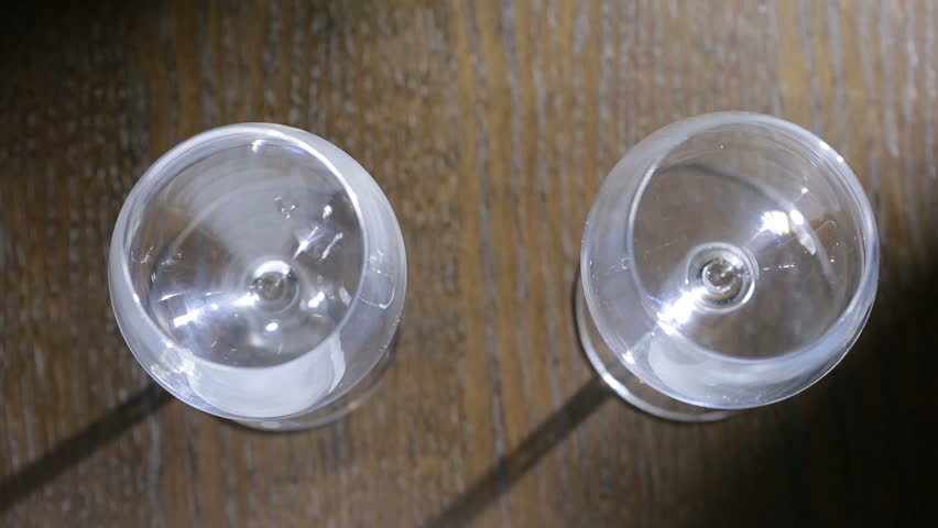 to pour two glasses of red wine. top view. Male and female hands