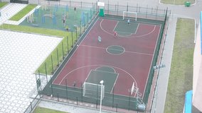 Children play soccer on the court. Video from the top.
