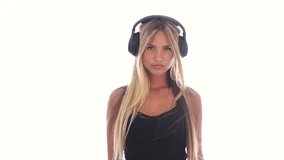 Woman flirting and listening music in headphones