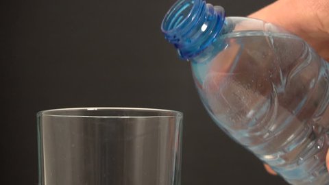 Pouring water from bottle into glass