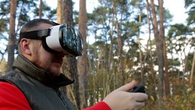 man with glasses of virtual reality in the autumn forest. VR