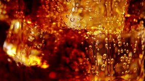 Cola background. Pouring Cola with Ice and bubbles in glass. Food background