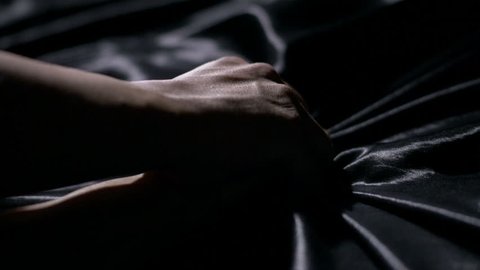 Making Love. Close-up of a man holding a woman's arms down in bed