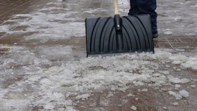 Footage man cleans snow from the yard shovel. slow motion 120 fps video