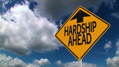 A road sign warns of hardship ahead.	 	