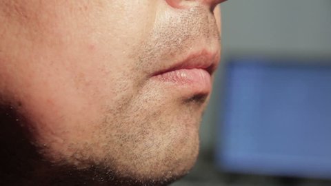 Close up man rubbing stubble on his face.