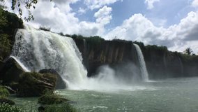 Dray Nur waterfall at the Tay Nguyen in Dal Lak Province, Vietnam. Beautiful asian cascade background with fresh white water, blue summer sky and clouds. 4k video (ultra-high definition) with sound.