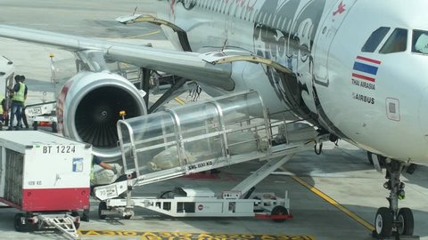 SINGAPORE - 28 AUG 2016: Baggage Unloading From Airplane in Airport After Landing