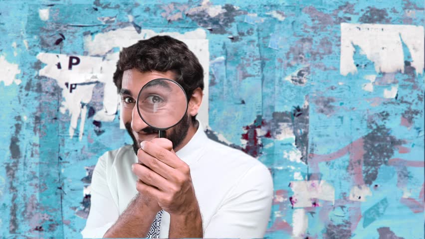 young man looking for pose against grunge wall