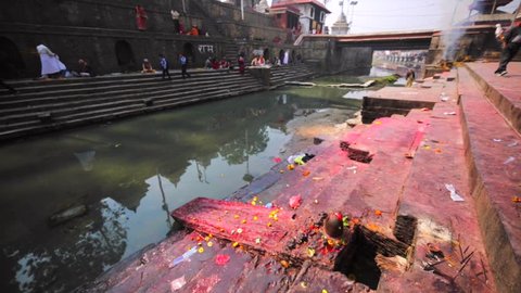 KATHMANDU, NEPAL - APRIL 11, 2016: Ritual place with lingams where ceremony of body washing in Bagmati river before cremation take place. Pashupatinath Temple, one of the sacred temples of Hindu faith
