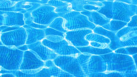 Clear blue outdoor swimming pool water rippling