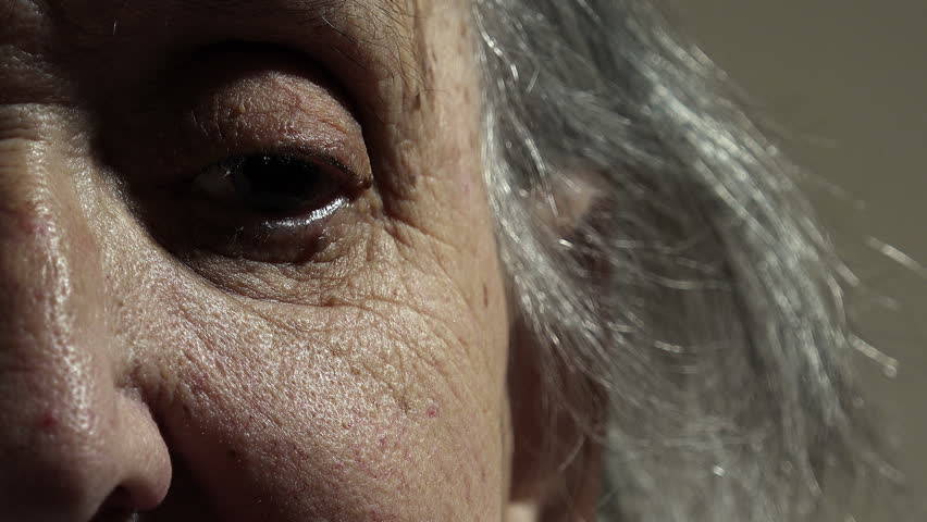Half face portrait of an old wrinkled woman sitting lonely at home | Shutterstock HD Video #21049102