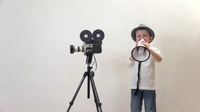 Little child speaking on megaphone close video camera