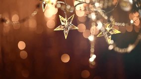 Christmas and New Year Background with Holiday Decoration garland, tinsel and stars. Abstract Blurred Bokeh Holiday Backdrop. Blinking Garland. Christmas Tree Lights Twinkling. Full HD 1080p video