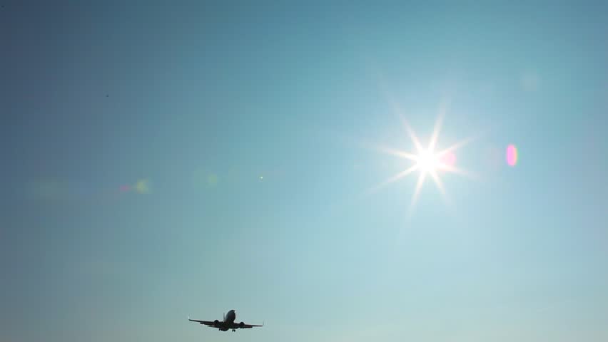 Airplane fly over on sunny day