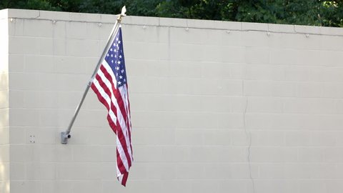 American Flag hanging on brick wall 4k
